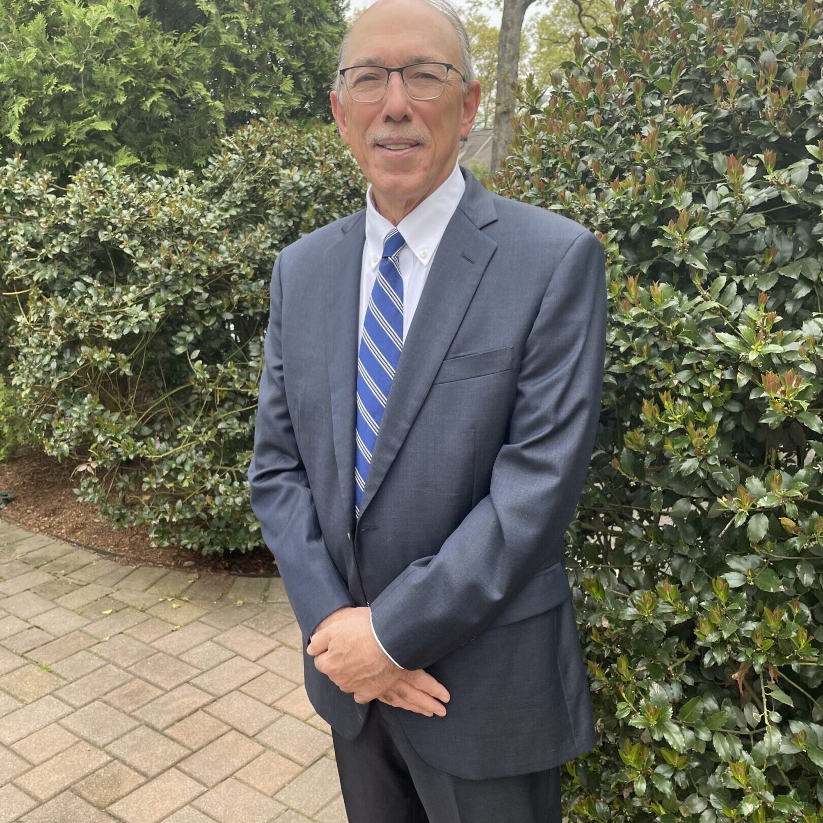 Man in suit and tie standing outdoors